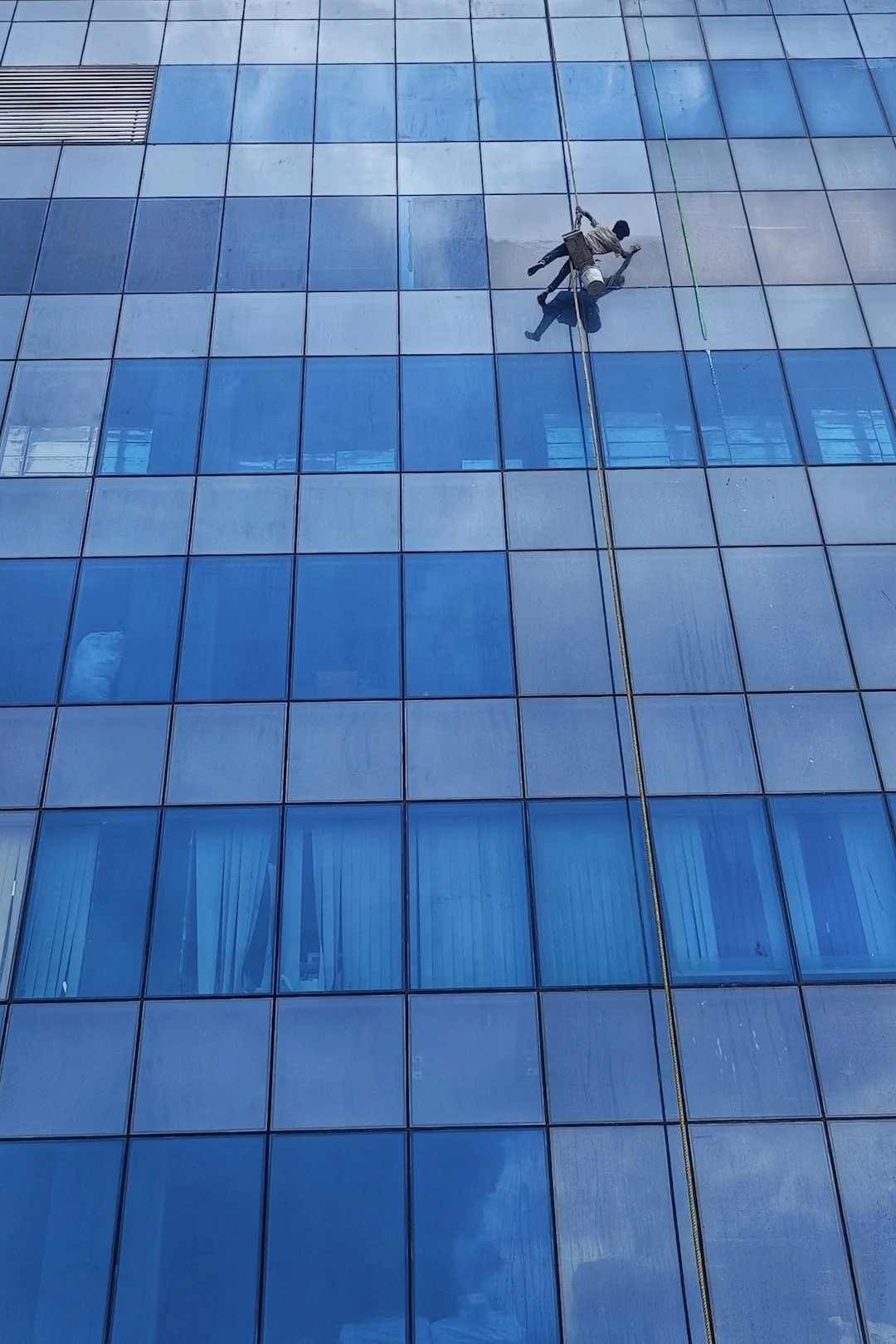 Colleagues interact in a modern office setting, blending technology with workplace hygiene.
